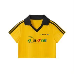 South Africa Cropped Jersey by Don Dimi Collective, a Haitian heritage brand, created as a cropped football piece that carries South African energy, color, movement, and cultural pride. This jersey brings women’s streetwear into football storytelling, made for fans who want a bold shape that reflects rhythm, identity, and the global influence of African football culture. South Africa Cropped Jersey by Don Dimi Collective, a Haitian heritage brand, created as a cropped football piece that carries South African energy, color, movement, and cultural pride. This jersey brings women’s streetwear into football storytelling, made for fans who want a bold shape that reflects rhythm, identity, and the global influence of African football culture.