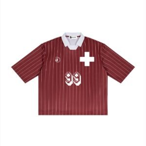 Switzerland Retro Football Jersey by Don Dimi Collective, a Haitian heritage brand, inspired by Switzerland’s clean beauty, mountain landscapes, lakes, villages, and sharp national identity. This jersey turns the calm power of Swiss scenery into a retro football piece, made for fans who connect sport with place, precision, travel, and timeless landscape design. Switzerland Retro Football Jersey par Don Dimi Collective, une marque d’héritage haïtien, inspiré par la beauté propre de la Suisse, ses paysages de montagne, ses lacs, ses villages et son identité nationale précise. Ce maillot transforme la puissance calme des paysages suisses en pièce de football rétro, faite pour les fans qui relient le sport au lieu, à la précision, au voyage et au design paysager intemporel