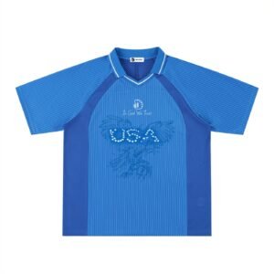 USA V-Neck Football Jersey by Don Dimi Collective, a Haitian heritage brand, built around a bold Donald Trump American football "Soccer" story that mixes Uncle Sam, cowboy energy, political satire, and the vastness of the United States. This V-neck jersey turns USA identity into a controversial streetwear image about power, myth, spectacle, and the way football culture can carry both pride and critique. United States of America V-Neck Football Jersey by Don Dimi Collective, a Haitian heritage brand, built around a bold Donald Trump football aka "Soccer" story that mixes Uncle Sam, cowboy energy, political satire, and the vastness of the United States. This V-neck jersey turns USA identity into a controversial streetwear image about power, myth, spectacle, and the way football culture can carry both pride and critique.